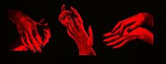 three hands reaching out to each other in the dark