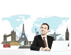 a man sitting at a desk with a laptop in front of him and the world map behind him