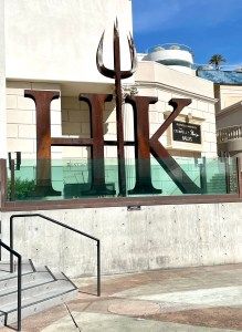 a large metal sign on the side of a building that says ark in front of it