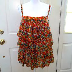 100% Cotton Free People Tiered Ruffle Top In A Gorgeous Green Orange Blue Floral Print 17” Pit To Pit Elastic On Back 22” Long Orange Ruffled Tops For Vacation, Orange Ruffled Top For Beach, Orange Ruffled Top For The Beach, Orange Ruffled Summer Top, Summer Orange Ruffle Tops, Summer Orange Ruffled Tops, Orange Summer Top With Ruffles, Summer Orange Top With Ruffles, Casual Orange Ruffled Top