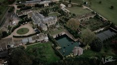 an aerial view of a large mansion with gardens