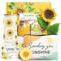 sunflowers and other items are arranged in a gift box with the message sending you sunshine