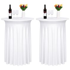 two white tables with wine bottles and glasses on them, one has flowers in the vase