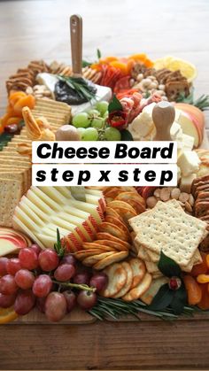 an assortment of cheeses, crackers and grapes on a platter