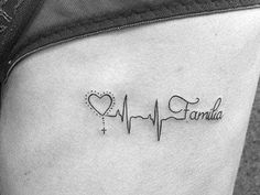 a small heartbeat tattoo with the word family on it