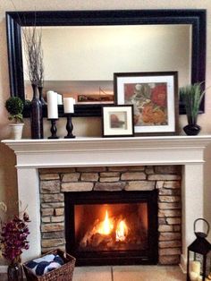 a fire place with pictures on the mantle and an instagram about it in front of a mirror