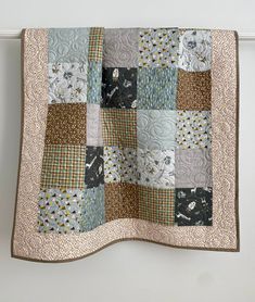 a patchwork quilt hanging on the wall