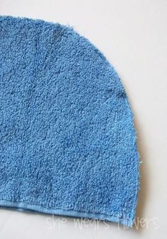 a close up of a blue towel on a white surface