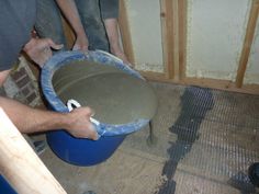 a man is pouring cement into a bucket