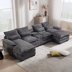 a living room with a large gray sectional couch