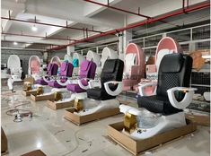 a room filled with lots of different types of hair dryers and chairs in it