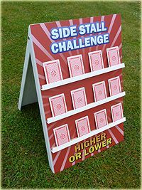 a sign on the grass that says side stall challenge higher or lower order than above it