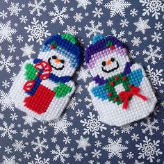 two knitted mittens with snowmen on them