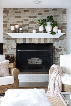 a living room filled with furniture and a fire place in front of a brick fireplace