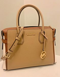 MICHAEL KORS MERCER MD BELTED SATCHEL CROSSBODY HANDBAG PURSE -CAMEL MULTI ABOUT THE ITEM MERCER SATCHEL BAG DETAILS Please look at approximate dimension below before purchasing.  APPROX. DIMENSIONS:  Length: 12 inches (L) Height: 9.5 inches (H) Depth: 5.5 inches (D Color: Camel Multi Size: Medium (M) Strap Length: 4.75 inches Adjustable from 20.5 inches to 24 inches 100% Authentic or Money Back Guarantee~~~ALWAYS!!! FEATURES: Gold Tone Hardware PVC Material Michael Kors Logo At Front Gold Toned Hardware MK Charm On Front Back & Front Slip Pockets Zip Top Closure Custom MK Fabric Lining Middle Zipper Compartment 2 Slip-in Pockets 1 Zipper Pocket Powered by ExportYourStore.com Michael Kors Beige Rectangular Satchel, Michael Kors Mercer, Michael Kors Logo, Bag Details, Satchel Bag, Pvc Material, Handbag Purse, Zip Top, Satchel Bags