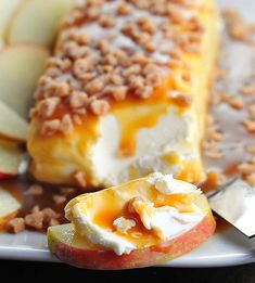 an apple dessert on a white plate with apples