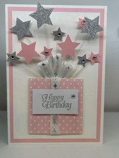 a birthday card with pink and silver stars