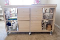 a baby changing table with several drawers and baskets