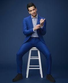 Stool Poses Photography Men, Male Suit Poses, Blue Background Photoshoot, Male Model Photoshoot Ideas, Sitting Poses Photography, Suit Poses, Background Sitting, Male Photoshoot, Men Poses