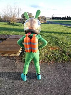 a little boy dressed up as a bunny with an inflatable ball on his head