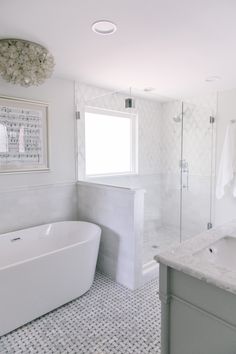 a white bath tub sitting next to a walk in shower