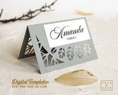 a table name card with leaves on it