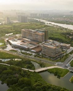 an aerial view of a large building in the middle of a river and lots of trees