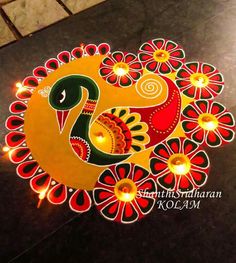 an artistic design on the floor with candles in it for diwaling and decorating