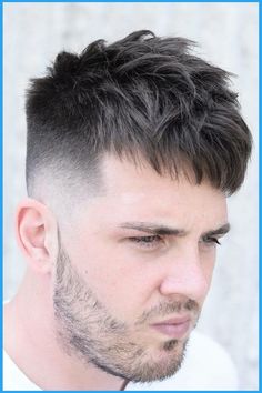 Man with a short textured haircut and fade, looking thoughtful.