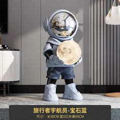 a statue of an astronaut holding the moon in his hands with chinese writing on it