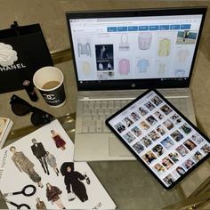 an open laptop computer sitting on top of a table next to a cup of coffee