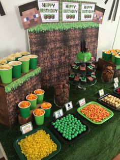 a table topped with lots of desserts and cupcakes on top of it