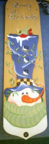 a wooden sign with a snowman on it's face and the words merry santa