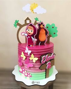 a birthday cake decorated with cartoon figures and decorations