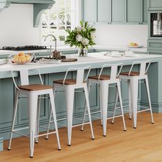 a kitchen with blue cabinets and white counter tops