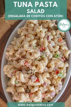 a bowl filled with pasta salad on top of a wooden table