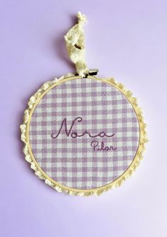 a close up of a small embroidered object on a purple background with the word, no more please