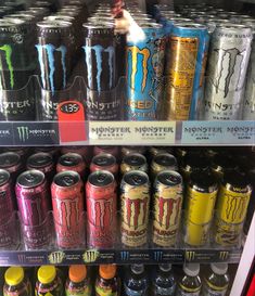 an assortment of monster energy drinks on display