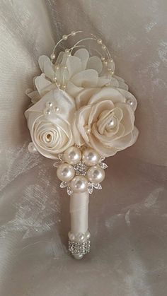 a bridal bouquet with white roses and pearls