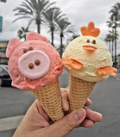 two ice cream cones with faces on them in front of a parking lot and palm trees