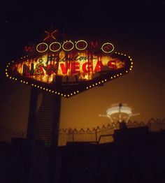 a neon sign that says welcome to new vegas