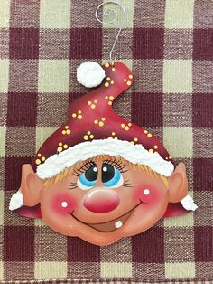 a christmas ornament with a red nose and hat on it's head