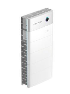 a white air purificater sitting on top of a white floor next to a wall