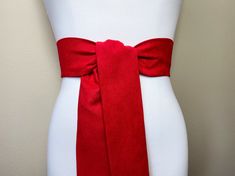 "Wide Ultra Suede Sash in True Red Suede Cloth Sash Belt Red Microsuede Sash Suede Accessories Christmas Red Ultrasuede Belt Satin Swank This Satin Swank® sash in true red micro suede fabric provides an instant update to your casual look. This one easy piece is three inches wide, 75 inches long, and will wrap around most waist sizes once with ample length remaining to tie in a bow or a simple knot with long-hanging tails. Flattering when positioned up high for an empire-waist effect, but may be Elegant Red Sash For Party, Elegant Red Party Sash, Suede Accessories, Bridesmaid Sash, Wedding Dress Sash, Denim Trench Coat, Satin Sash, Dress Sash, Brown Satin