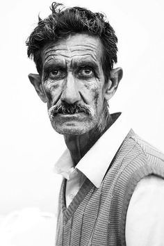 black and white photograph of an old man with wrinkles on his face