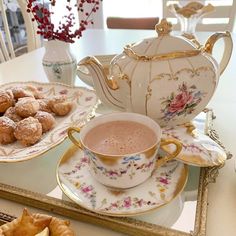 a cup of coffee and some pastries on a table