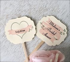 two wedding fans with pink flowers on them