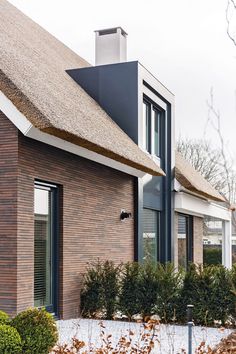 a brick house with a thatched roof