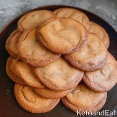 a pile of cookies sitting on top of a black plate