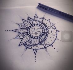 a drawing of a sun with a face on it's side, sitting next to a pen